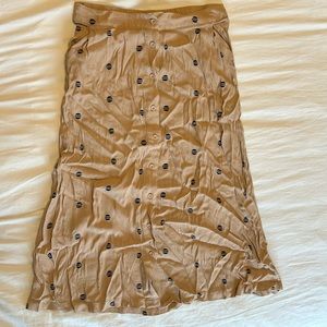 Mid-length skirt, tan with navy dots. Button-down front.